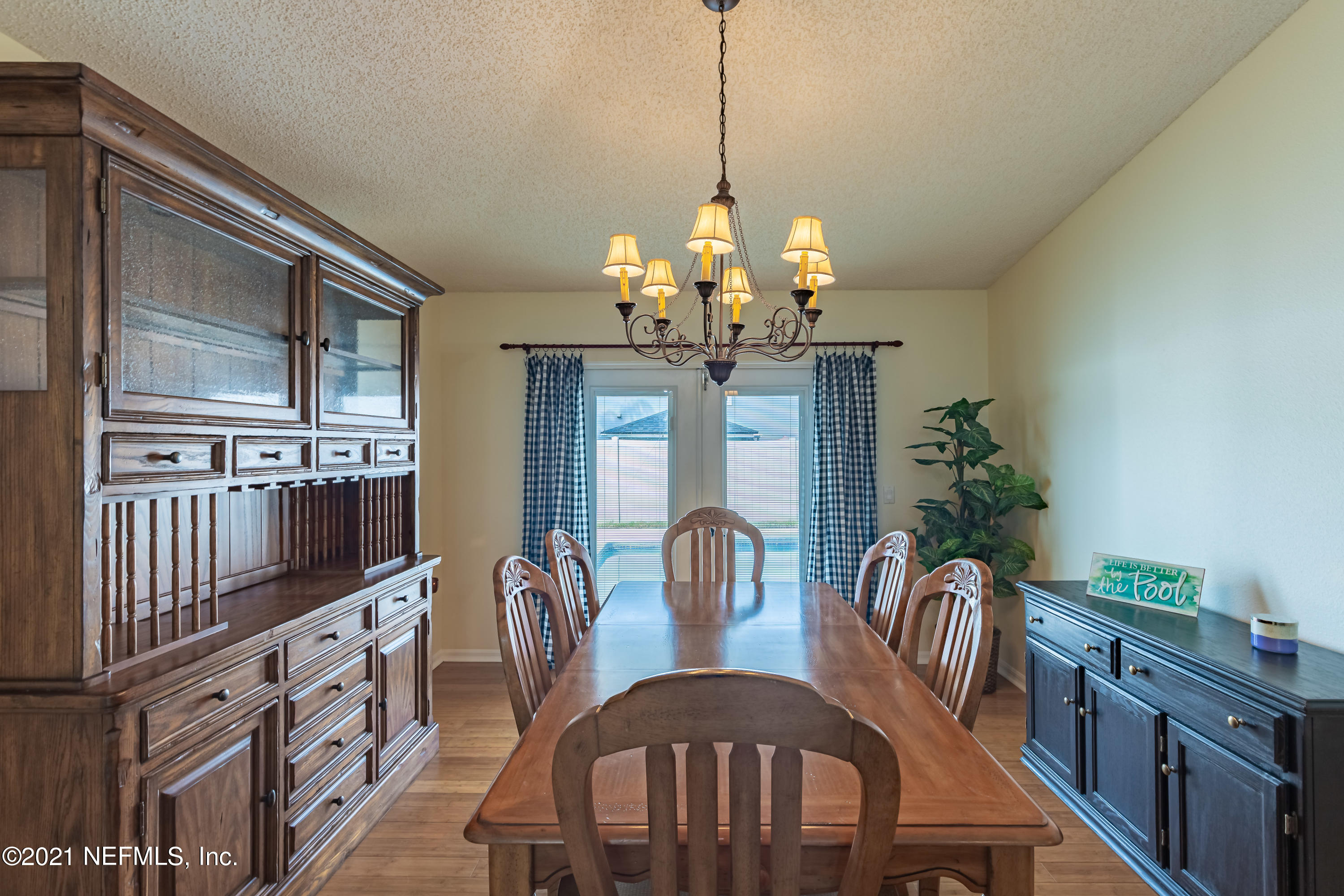2602 Sunrise Ridge Lane Jacksonville, FL 32277 - Photo 17 of 35 a view of a dining room with furniture a chandelier and wooden floor