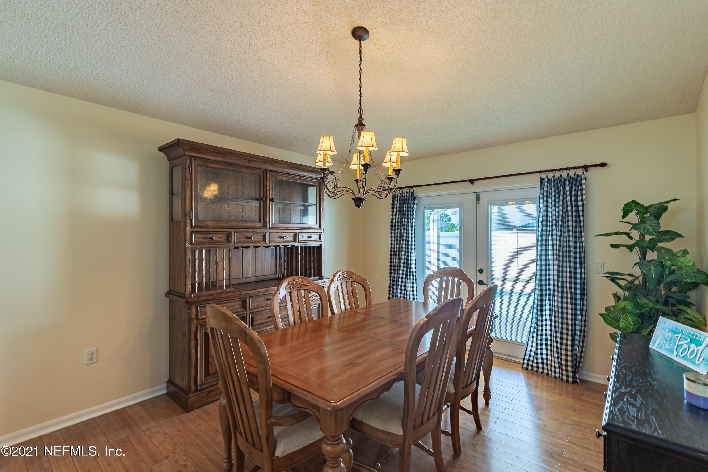 2602 Sunrise Ridge Lane Jacksonville, FL 32277 - Photo 18 of 35 a view of a dining room with furniture and wooden floor