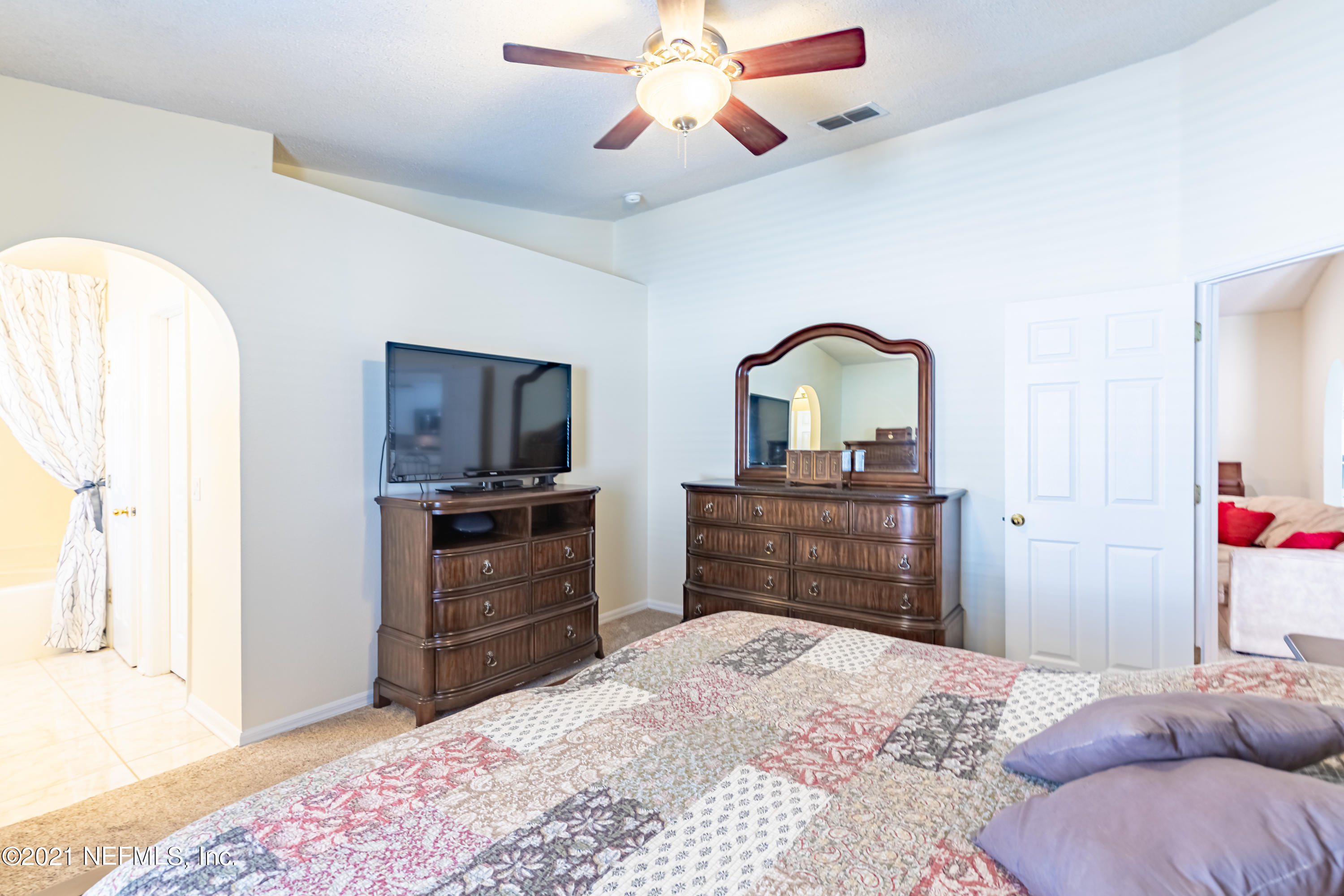 2602 Sunrise Ridge Lane Jacksonville, FL 32277 - Photo 19 of 35 a bedroom with a bed and a dresser
