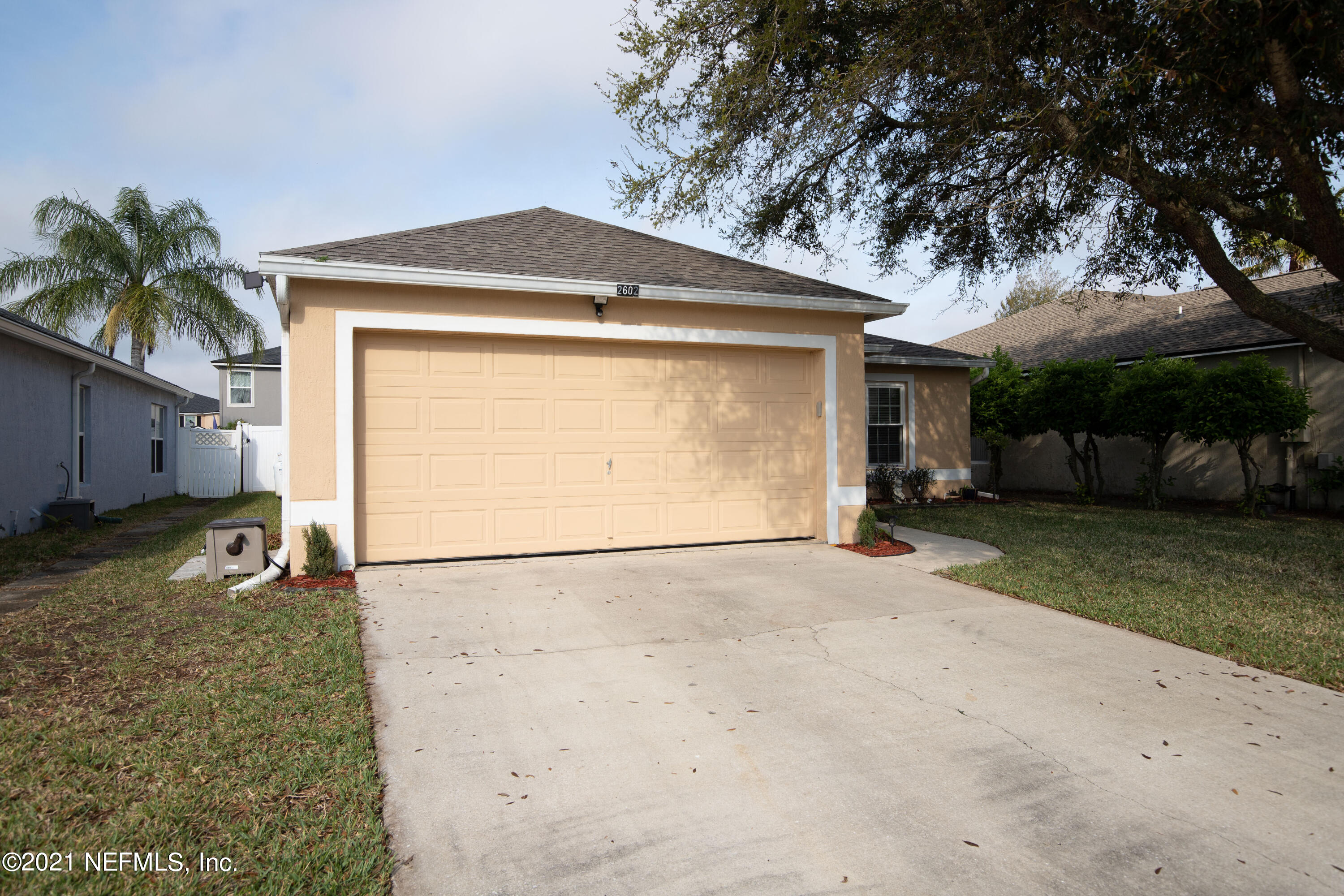 2602 Sunrise Ridge Lane Jacksonville, FL 32277 - Photo 2 of 35 a front view of a house with a yard and garage