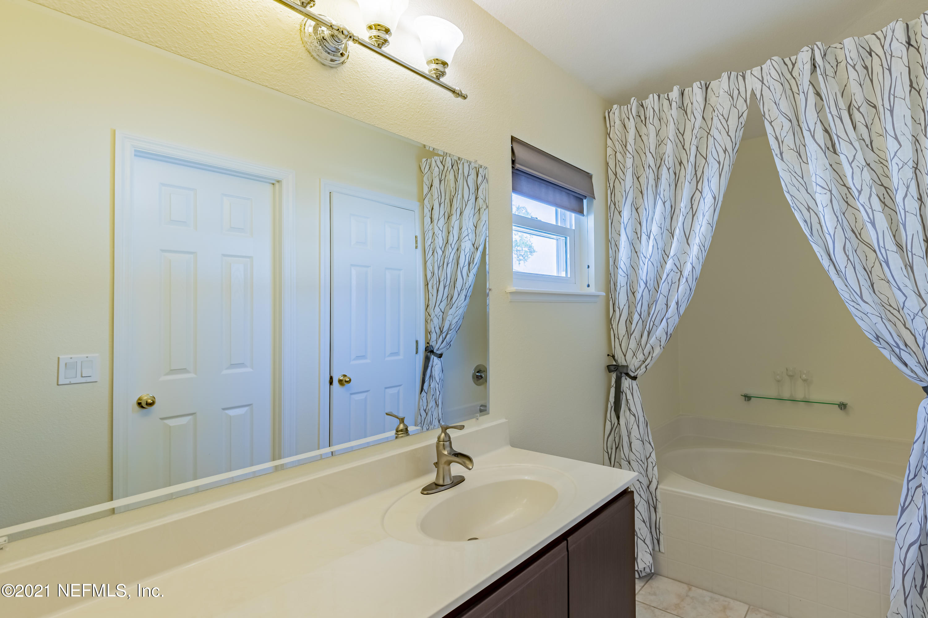 2602 Sunrise Ridge Lane Jacksonville, FL 32277 - Photo 24 of 35 a bathroom with a sink a toilet and shower