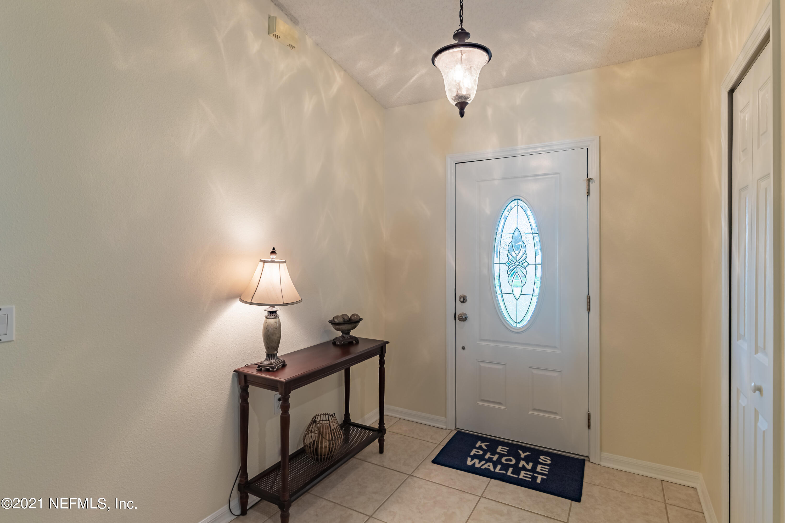 2602 Sunrise Ridge Lane Jacksonville, FL 32277 - Photo 6 of 35 a view of a hallway with chandelier fan