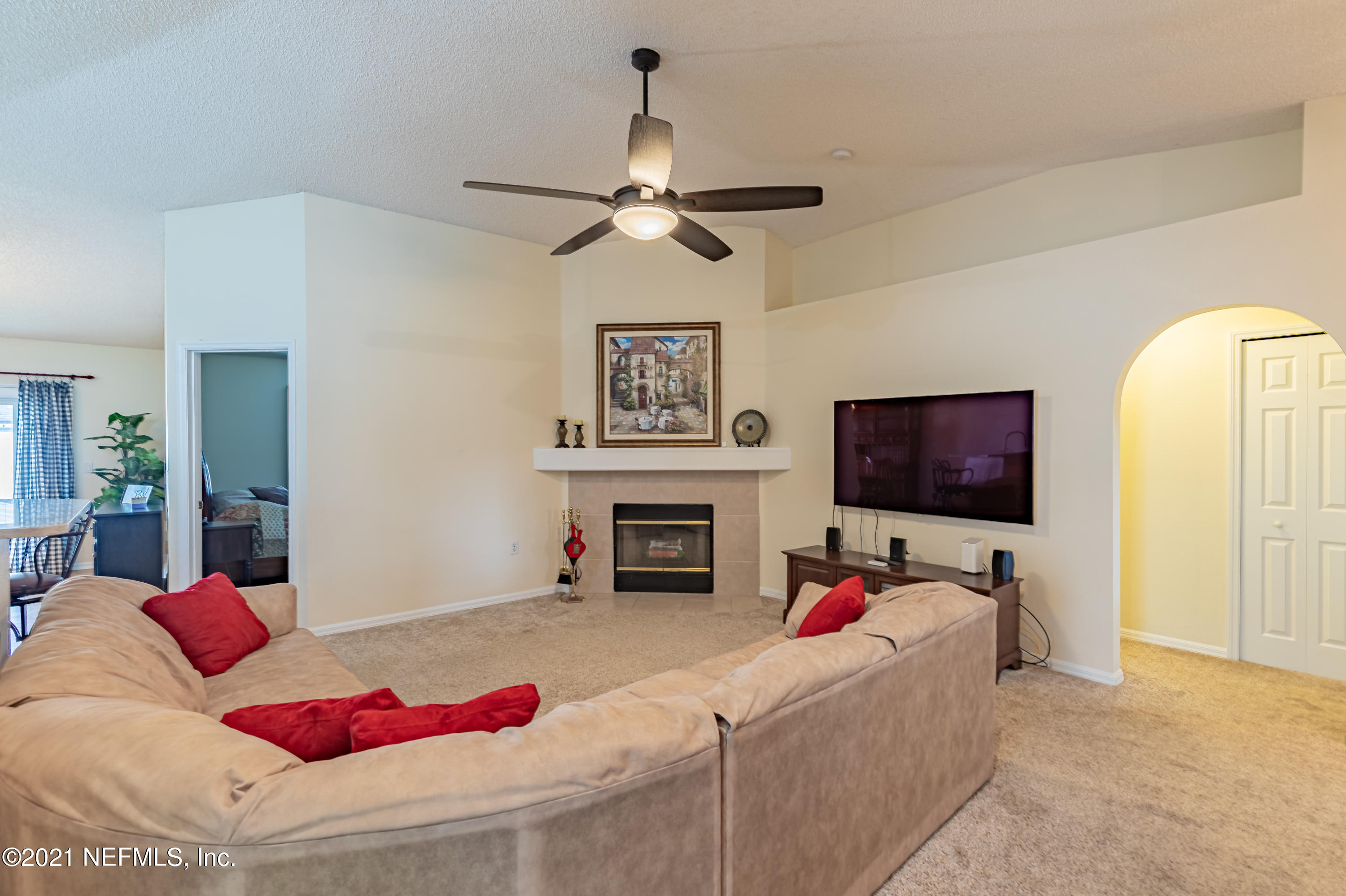 2602 Sunrise Ridge Lane Jacksonville, FL 32277 - Photo 8 of 35 a living room with fireplace furniture and a flat screen tv