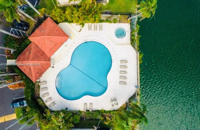 an aerial view of a house with swimming pool and outdoor space