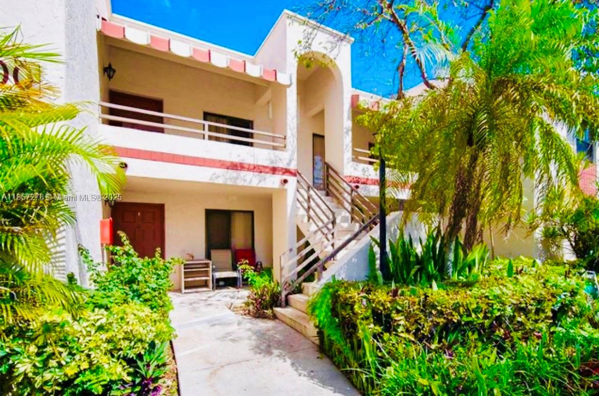 20300 Northeast 3rd Court, Unit 6 Miami, FL 33179 - Photo 4 of 14 a front view of a house with a yard