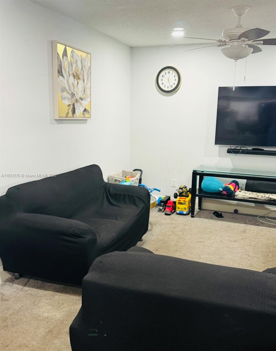20300 Northeast 3rd Court, Unit 6 Miami, FL 33179 - Photo 6 of 14 a living room with furniture and a flat screen tv
