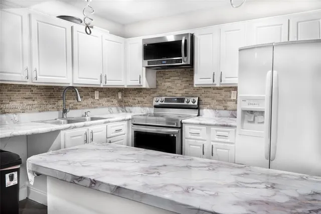 a kitchen with a refrigerator stove and microwave