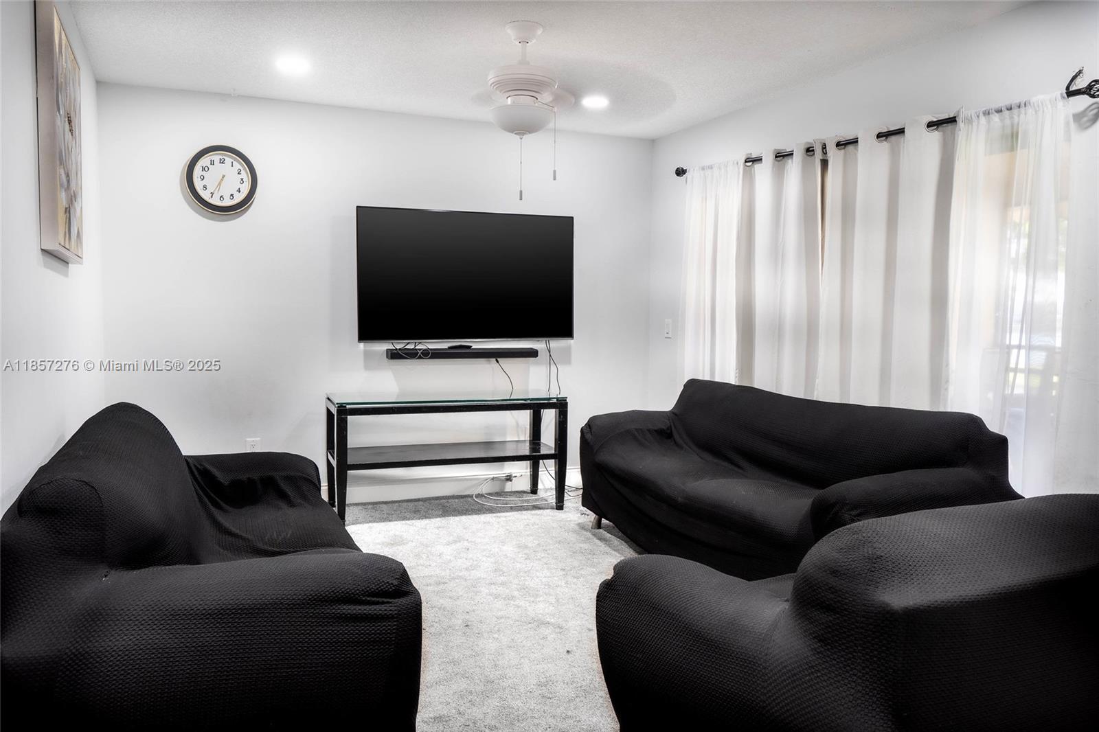 20300 Northeast 3rd Court, Unit 6 Miami, FL 33179 - Photo 8 of 14 a living room with furniture and a flat screen tv