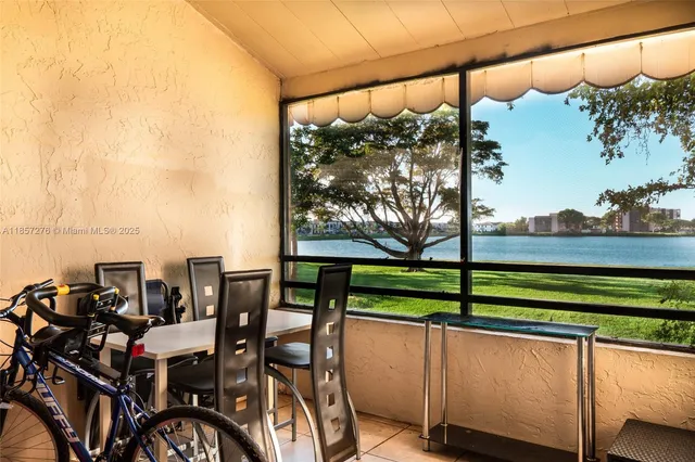 a view of a chairs and table in the balcony