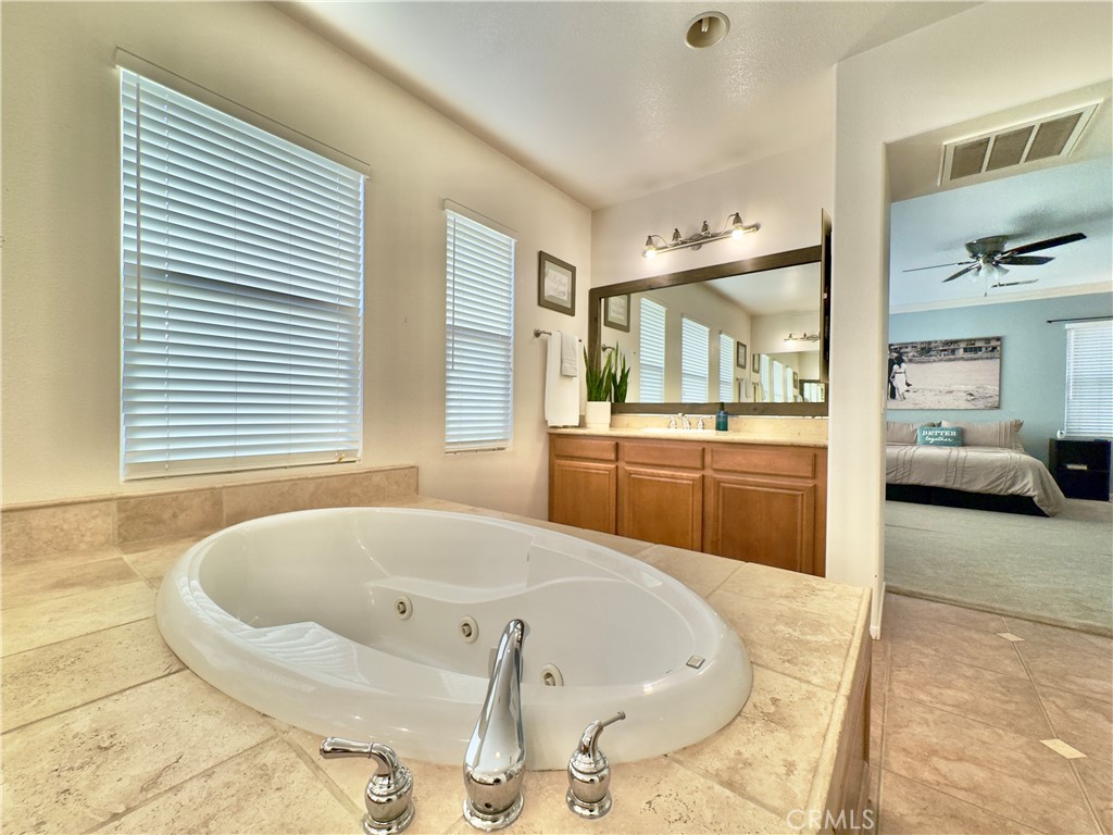11265 Runyan Road Beaumont, CA 92223 - Photo 2 of 138 a bathroom with a tub sink and mirror
