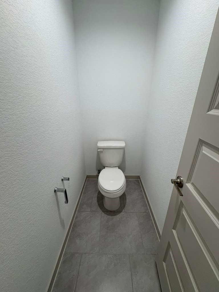 30018 Reagans Rnch Drive Fulshear, TX 77494 - Photo 23 of 30 a white toilet sitting in a bathroom