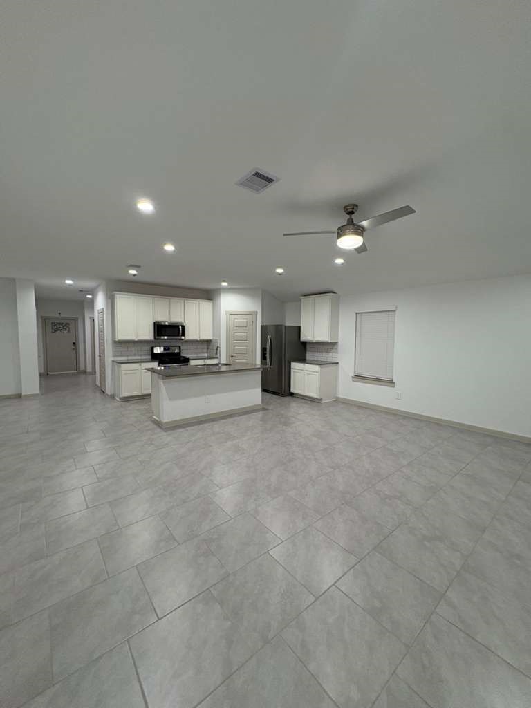 30018 Reagans Rnch Drive Fulshear, TX 77494 - Photo 8 of 30 a view of kitchen with kitchen island a sink stainless steel appliances and cabinets