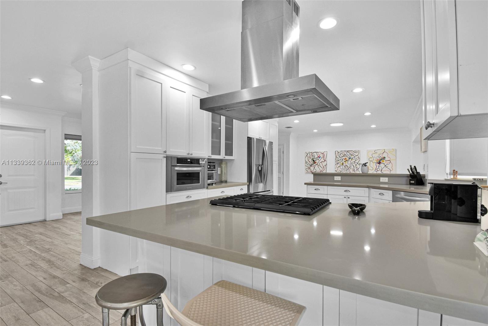 Dadeland Miami, FL 33173 - Photo 17 of 56 a kitchen with stainless steel appliances a table and chairs in it