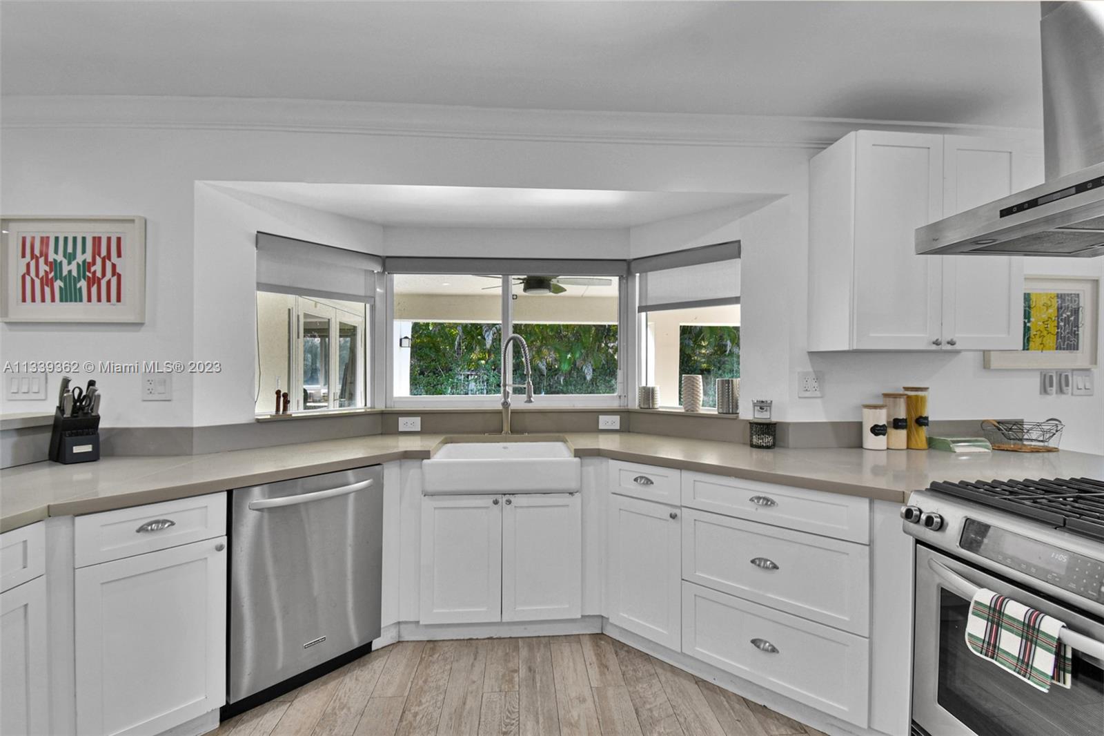 Dadeland Miami, FL 33173 - Photo 19 of 56 a kitchen with white cabinets and white appliances