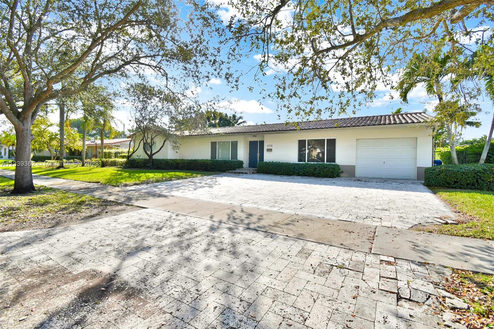 Dadeland Miami, FL 33173 - Photo 2 of 56 a front view of a house with a yard and trees