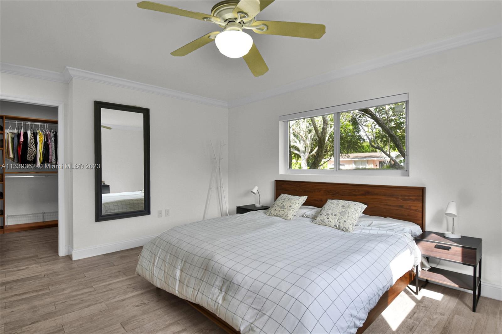 Dadeland Miami, FL 33173 - Photo 25 of 56 a bedroom with a bed and a chandelier