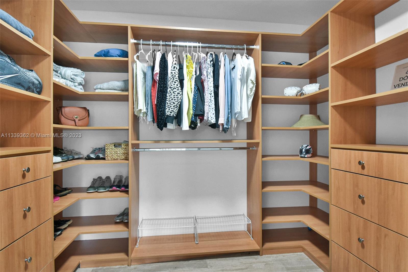 Dadeland Miami, FL 33173 - Photo 27 of 56 a view of walk in closet with clothes and shoes