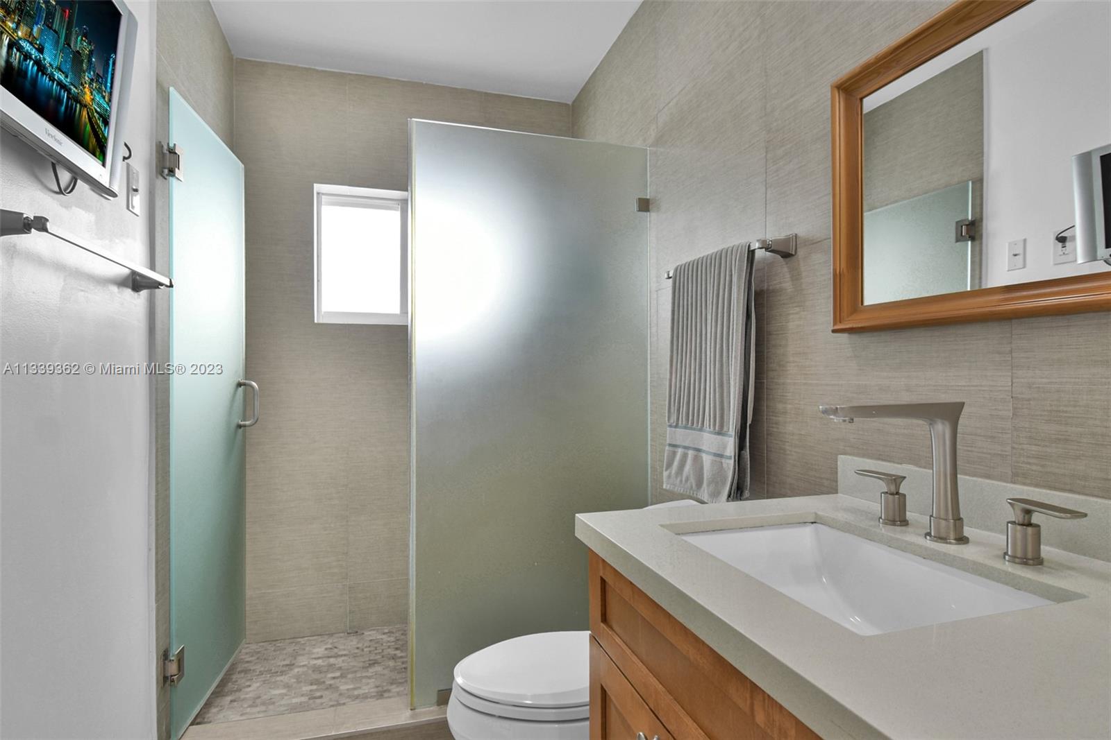 Dadeland Miami, FL 33173 - Photo 28 of 56 a bathroom with a sink toilet vanity and shower