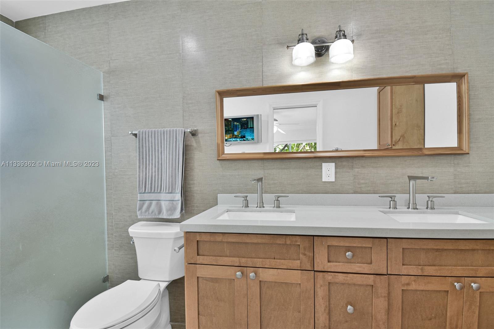 Dadeland Miami, FL 33173 - Photo 29 of 56 a bathroom with a toilet sink and mirror