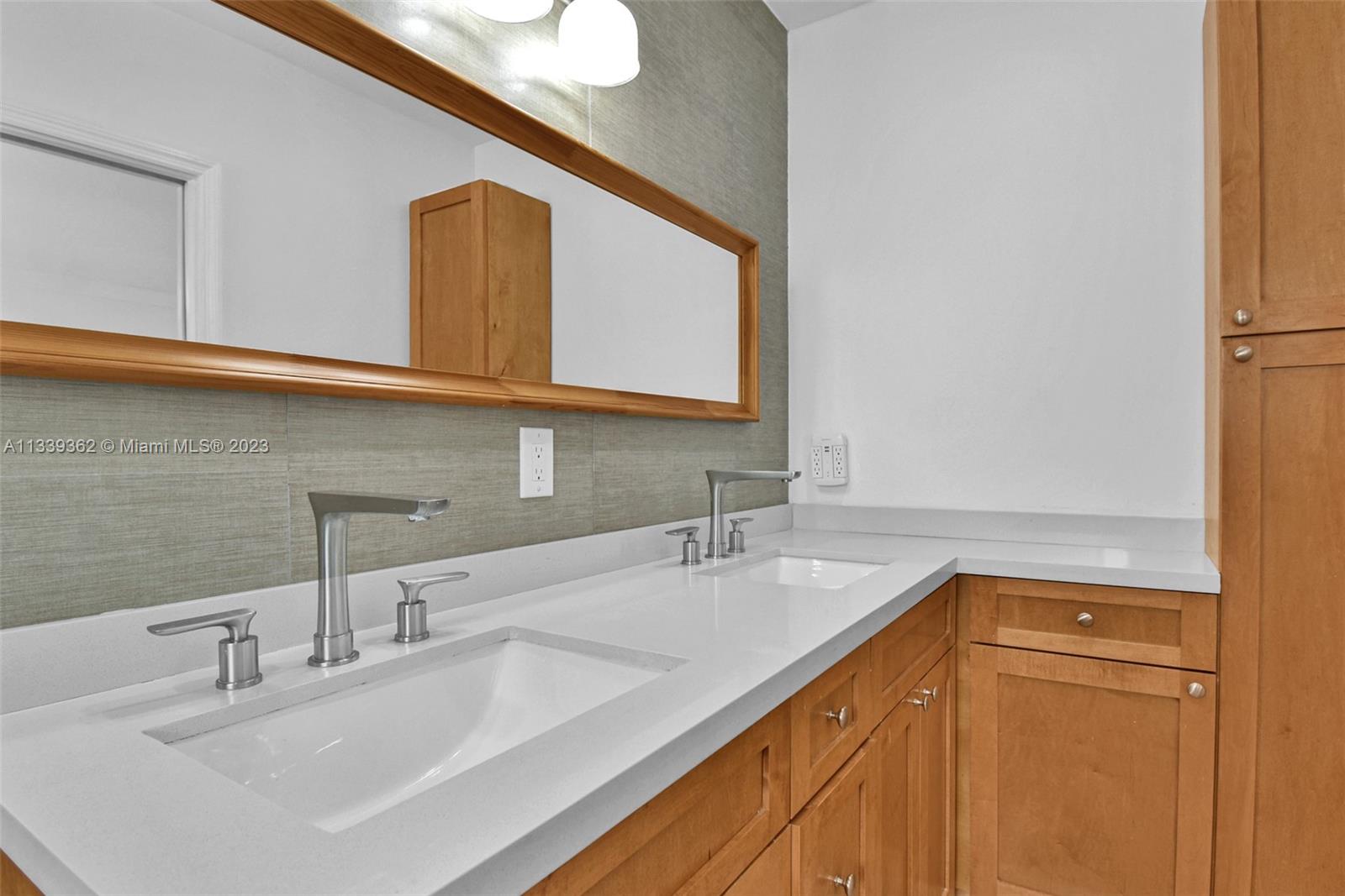 Dadeland Miami, FL 33173 - Photo 30 of 56 a bathroom with a sink and a mirror