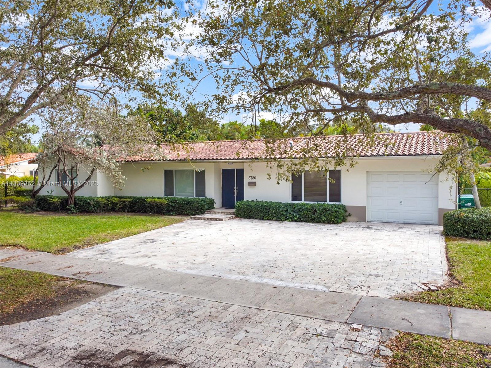 Dadeland Miami, FL 33173 - Photo 3 of 56 a front view of a house with a yard and potted plants