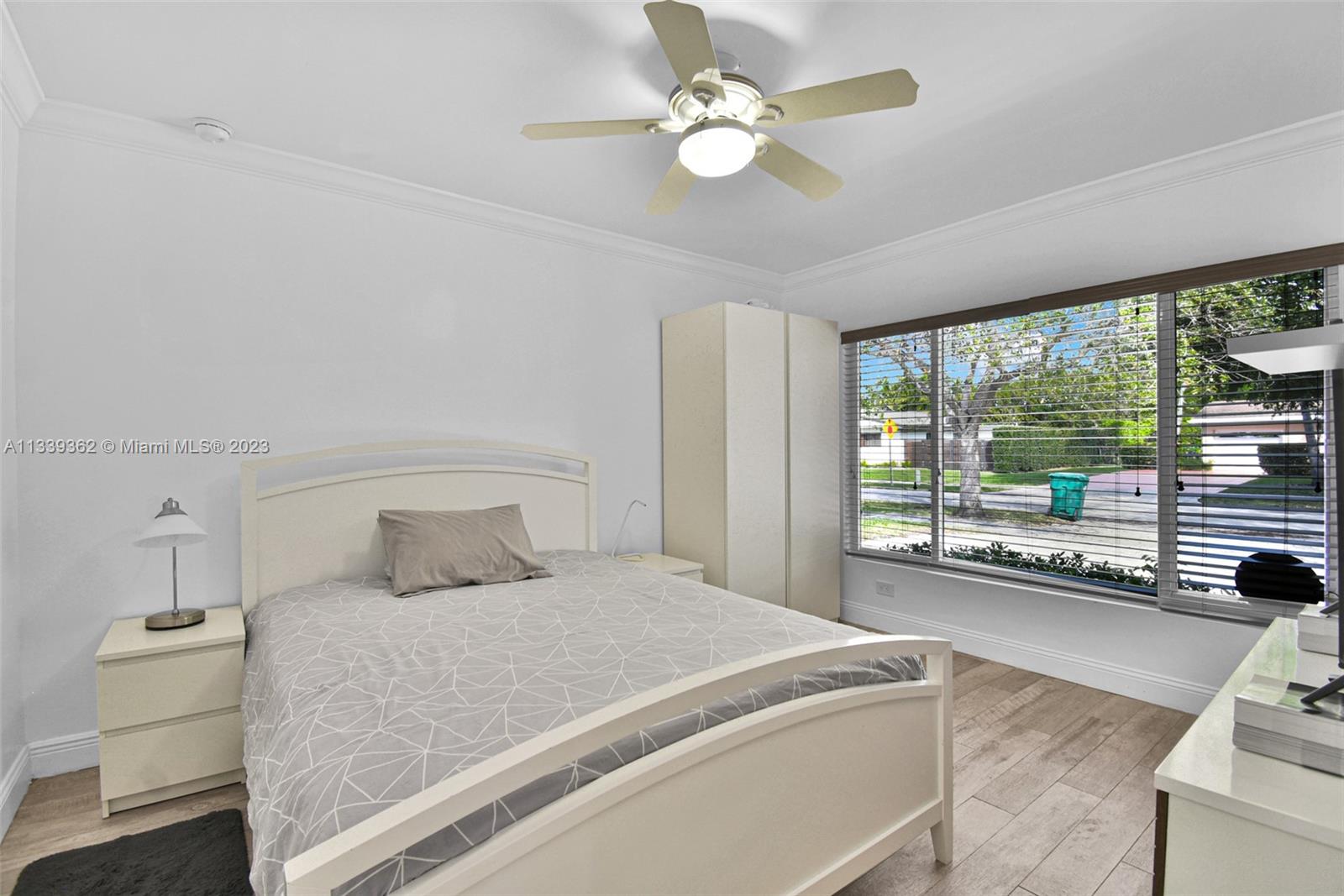 Dadeland Miami, FL 33173 - Photo 38 of 56 a bedroom with a large bed and a large window with outer view