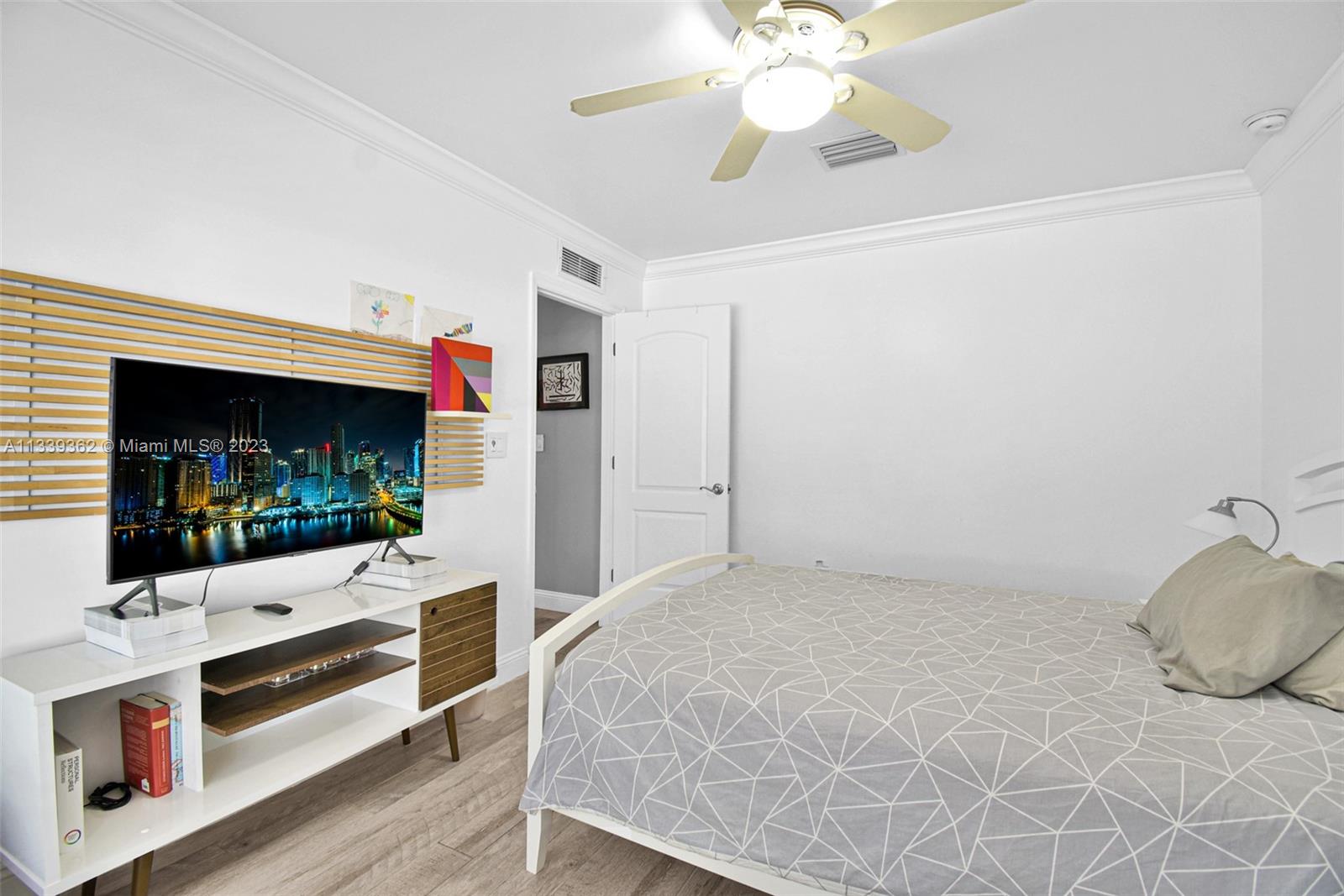 Dadeland Miami, FL 33173 - Photo 40 of 56 a bedroom with a bed and a flat screen tv