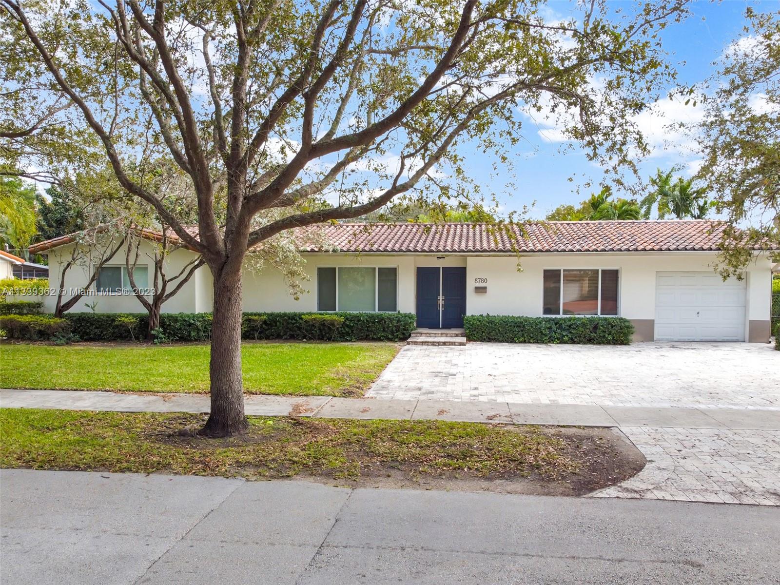 Dadeland Miami, FL 33173 - Photo 4 of 56 a front view of a house with a yard and garage