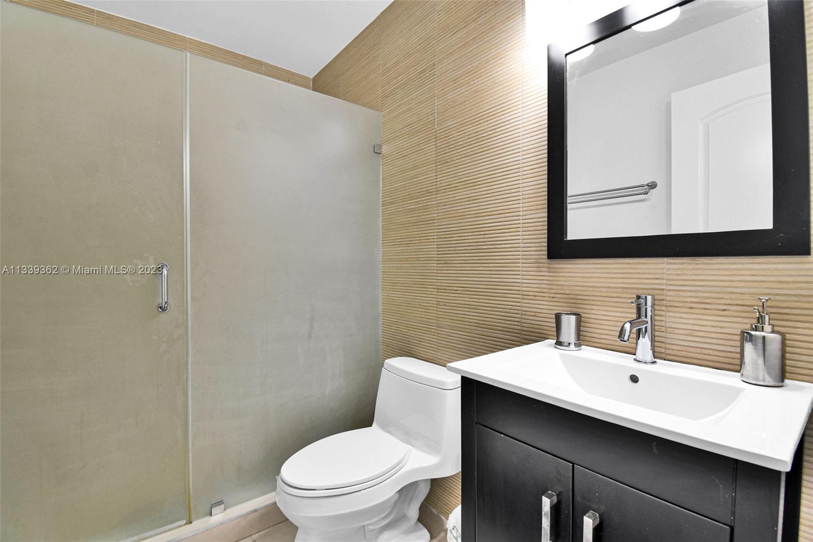 Dadeland Miami, FL 33173 - Photo 41 of 56 a bathroom with a toilet a sink and mirror