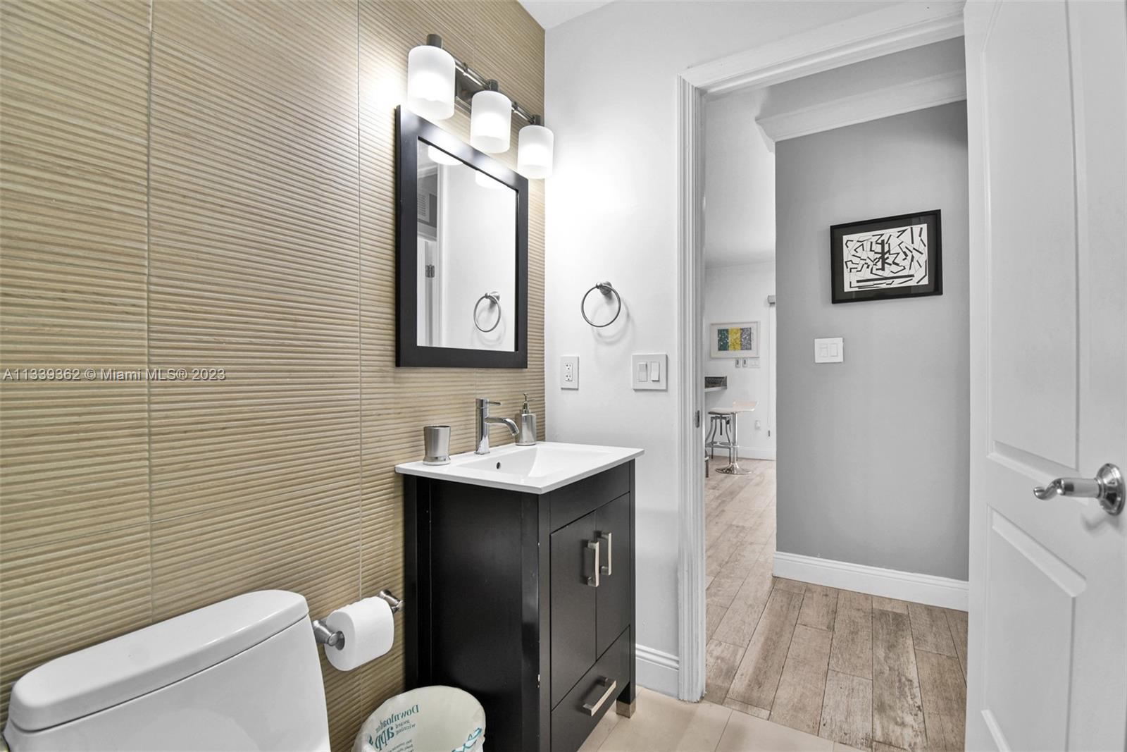 Dadeland Miami, FL 33173 - Photo 42 of 56 a bathroom with a toilet a sink and mirror