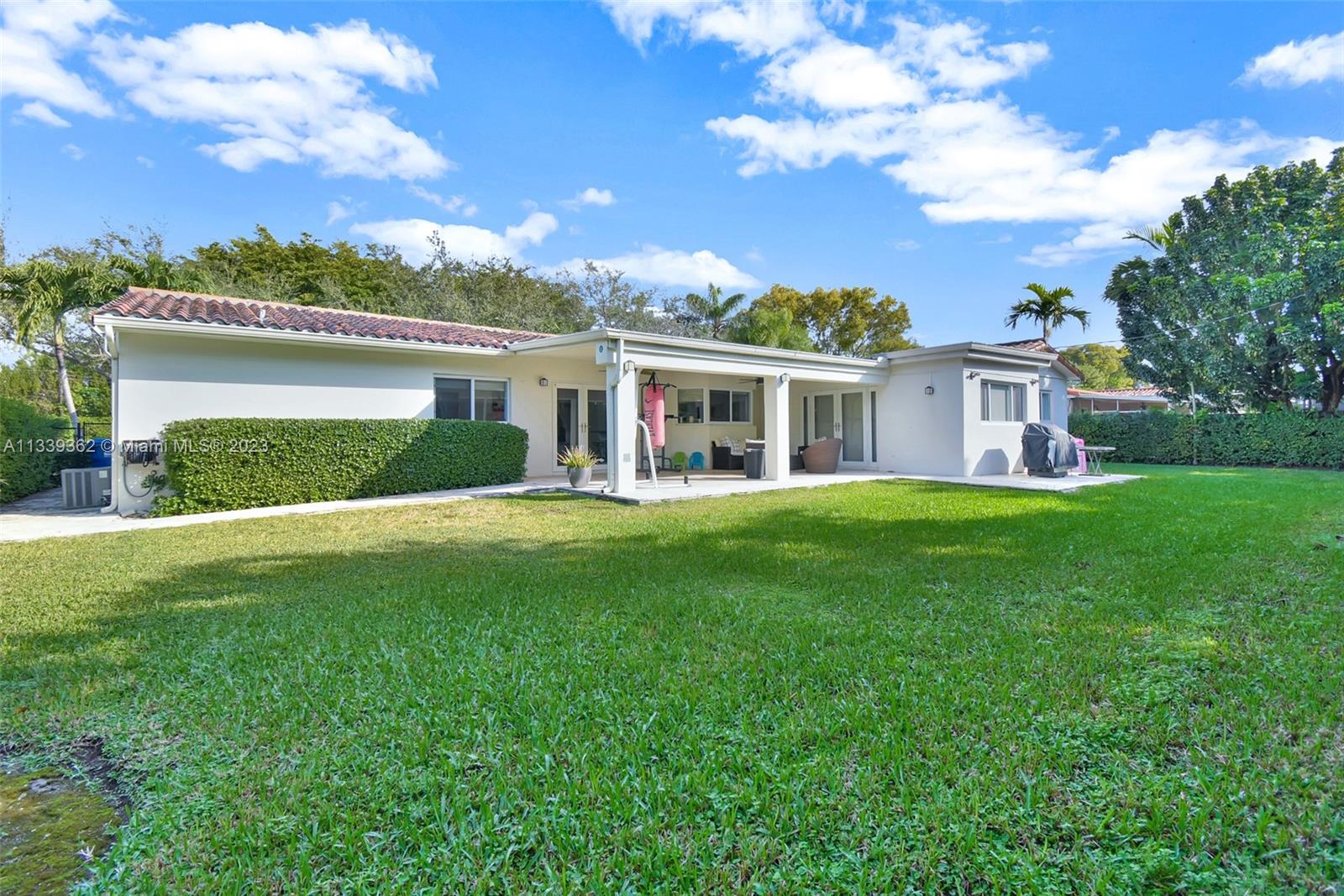 Dadeland Miami, FL 33173 - Photo 52 of 56 a front view of house with yard and green space