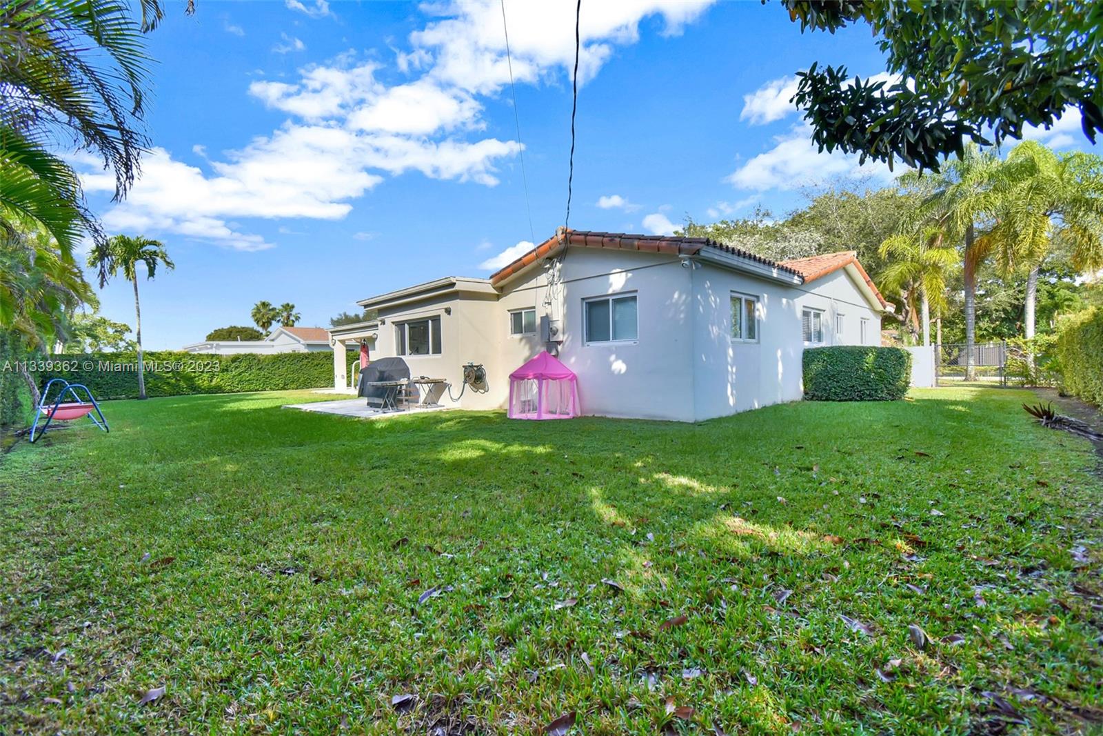 Dadeland Miami, FL 33173 - Photo 53 of 56 a front view of house with yard and green space