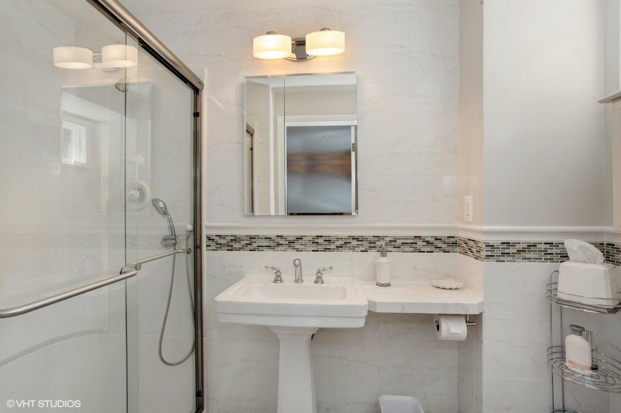 18 Quamhassett Road Buzzards Bay, MA 02532 - Photo 12 of 31 a bathroom with a sink a toilet and shower
