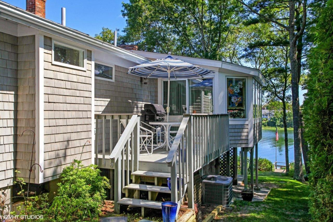 18 Quamhassett Road Buzzards Bay, MA 02532 - Photo 17 of 31 a front view of a house with a yard