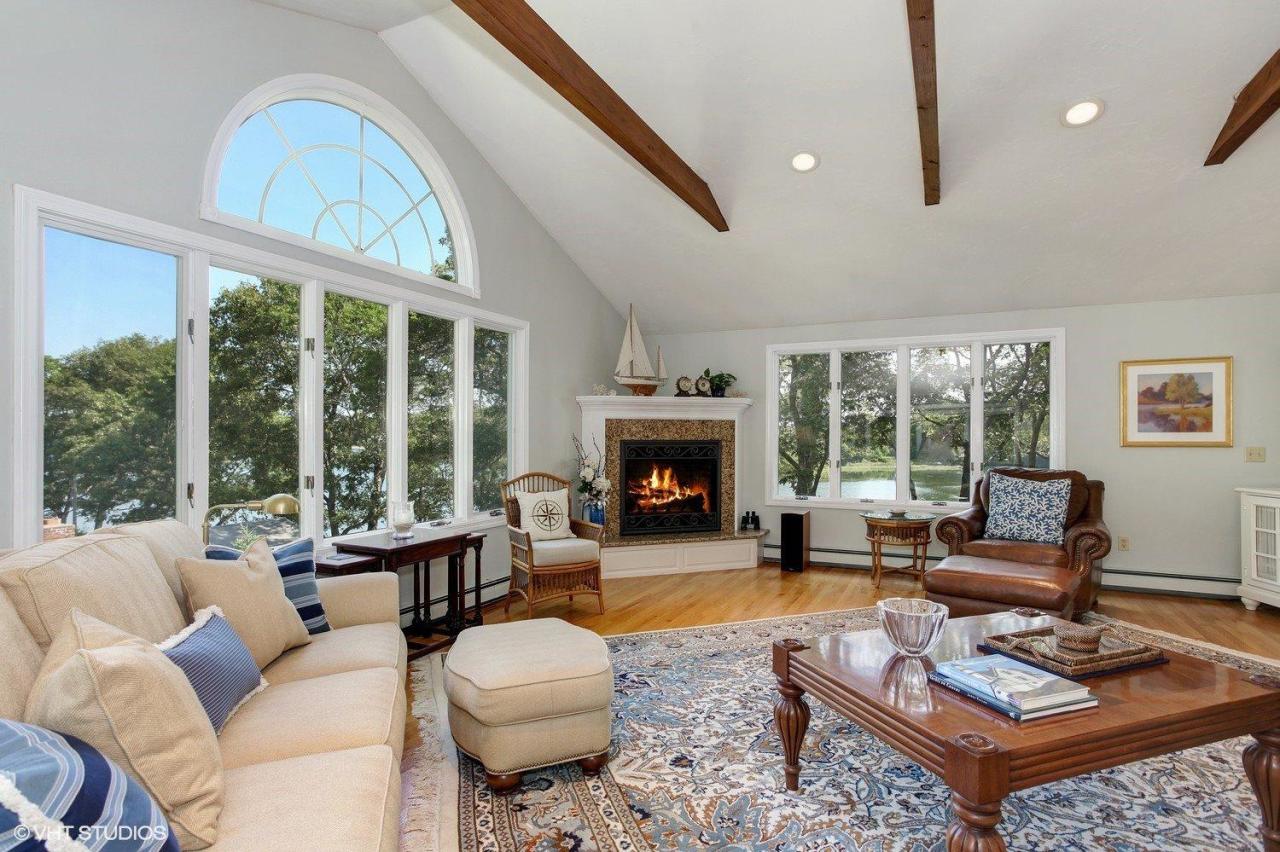 18 Quamhassett Road Buzzards Bay, MA 02532 - Photo 3 of 31 a living room with furniture a large window and a fireplace