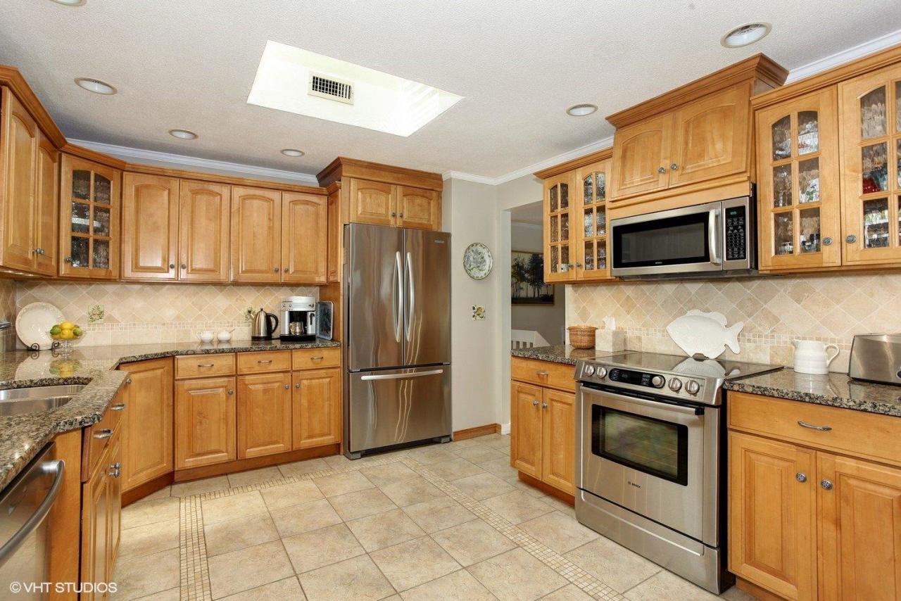 18 Quamhassett Road Buzzards Bay, MA 02532 - Photo 8 of 31 a kitchen with stainless steel appliances granite countertop a stove top oven microwave and refrigerator