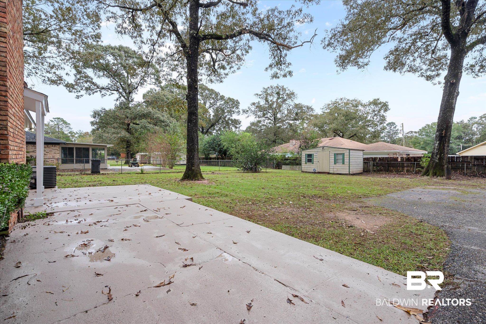 5015 Golfway Drive Eight Mile, AL 36613 - Photo 31 of 31 Exterior space with central AC and a shed