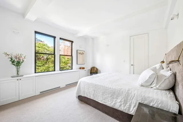 a bedroom with a large bed and a window