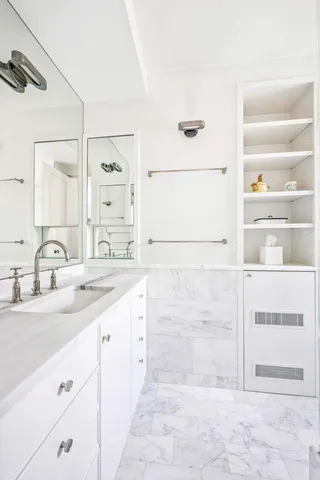 a bathroom with a double vanity sink a mirror and shower