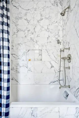 a white bath tub sitting in a bathroom