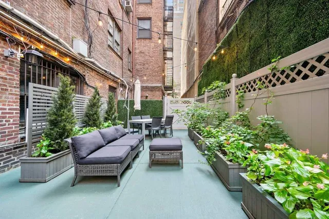 a building outdoor space with patio furniture and potted plants