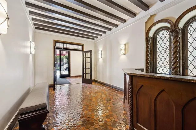 a view of a livingroom with wooden floor and furniture