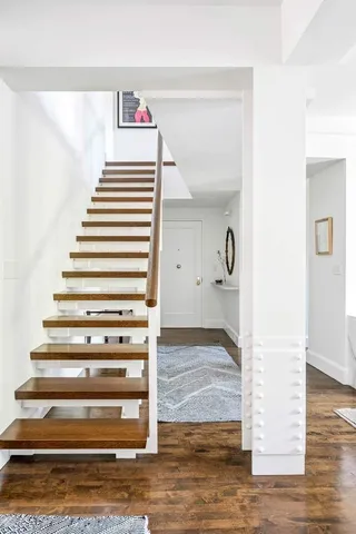a view of entryway and hall with wooden floor