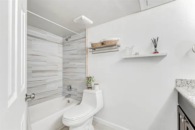 a bathroom with a shower a toilet and a sink