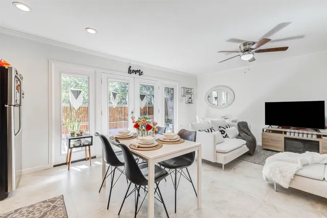 a living room with furniture a flat screen tv and a large window