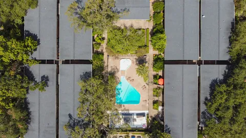 an aerial view of a house with a yard and garden