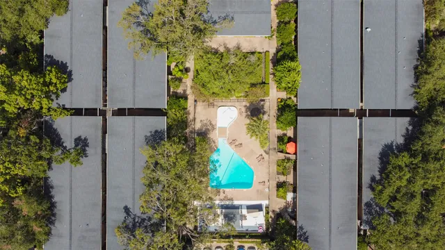 an aerial view of a house with a yard and garden