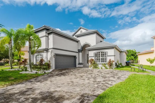 a front view of a house with garden