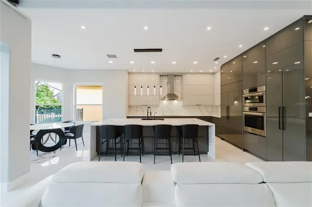 a large kitchen with a table and chairs