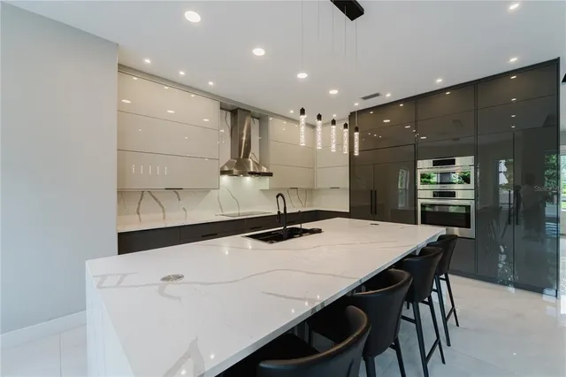 a kitchen with a table chairs sink and cabinets
